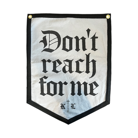 Knocked Loose's "Don't Reach For Me" design, custom printed on the front of a 18" X 24" grey 5 sided hanging camp flag.