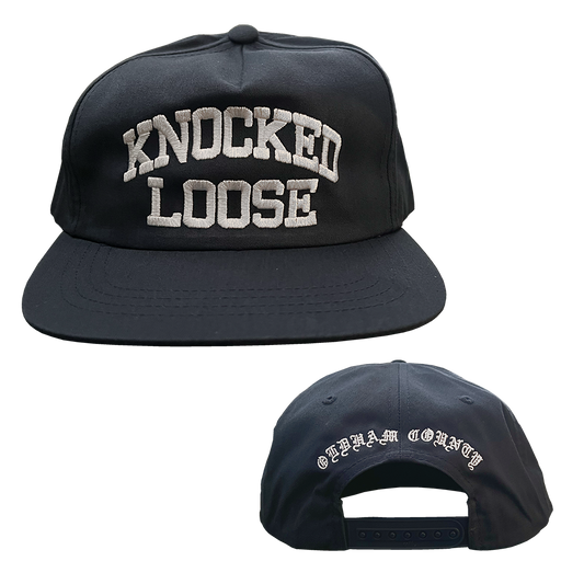 Knocked Loose's "Varsity Arch" design embroidered on the front and back of a navy Yupoong Snapback.